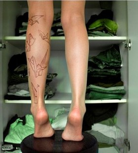 Paper art origami tattoo on leg