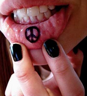 Peace sign inside bottom lips tattoo