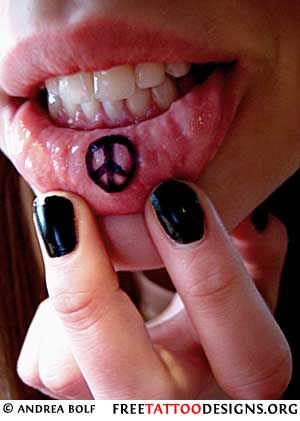 Peace sign inside bottom lips tattoo