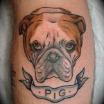 Pig and angry dog tattoo on arm