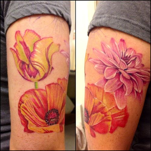 Pink, yellow and orange poppy tattoo on arm