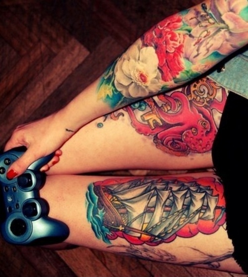 Playstation and girl ship tattoo on leg