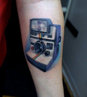 Pretty blue camera tattoo on arm