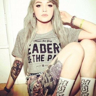 Pretty girl and wolf tattoo on leg