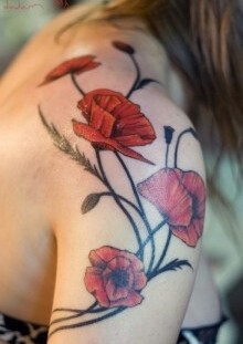 Pretty girl poppy tattoo on arm