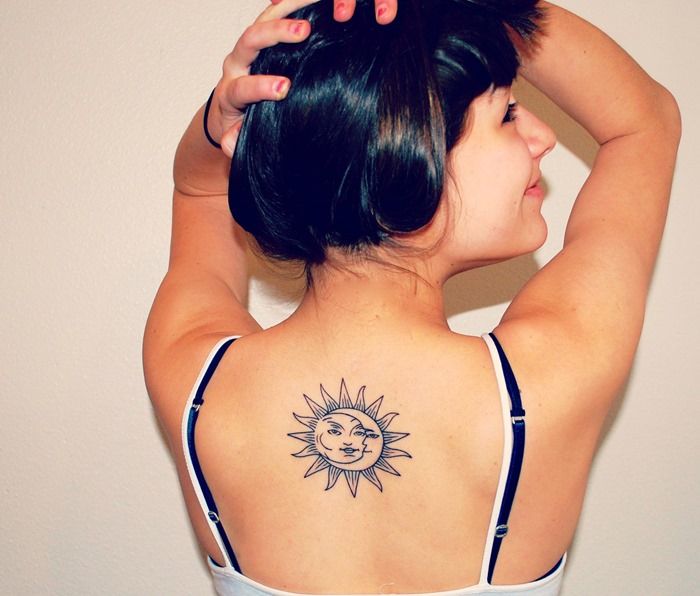 Pretty girl’s back moon tattoo