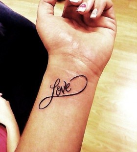 Pretty nails and love tattoo on arm
