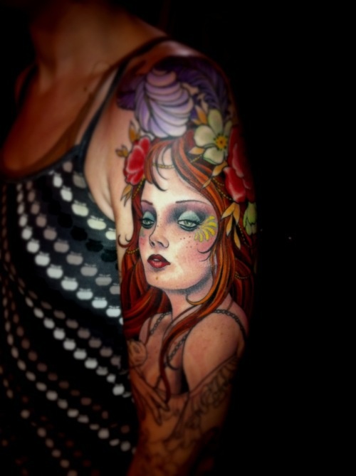 Pretty red hair girl’s face tattoo on arm