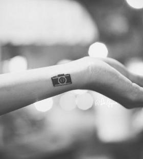 Pretty small camera tattoo on arm