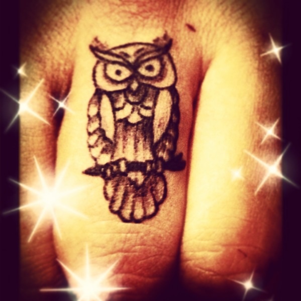 Pretty stars and owl tattoo on finger