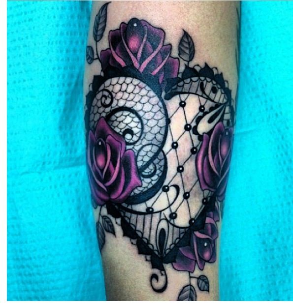 Purple rose and lace tattoo on arm