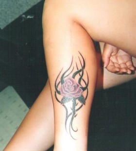 Purple rose and tribal tattoo on leg