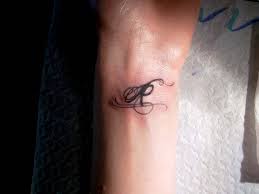R letter tattoo on wrist