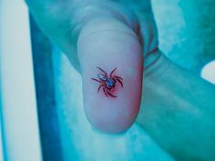 Realistic spider tattoo on thumb