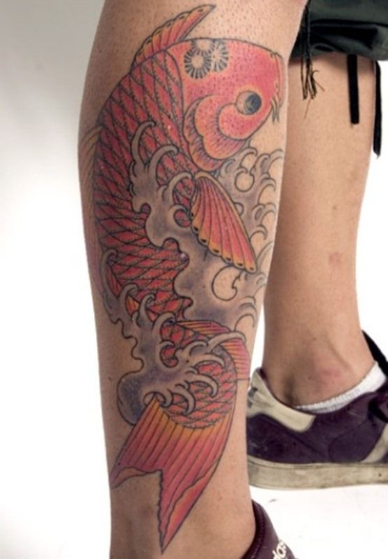 Red adorable fish tattoo on leg