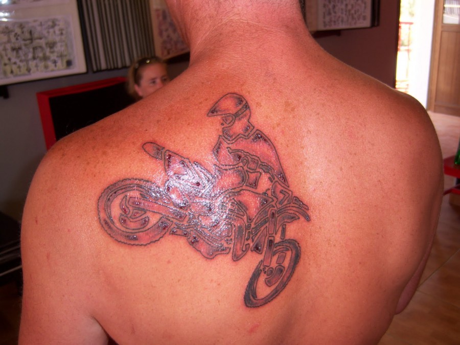Red amazing bicycle tattoo on back