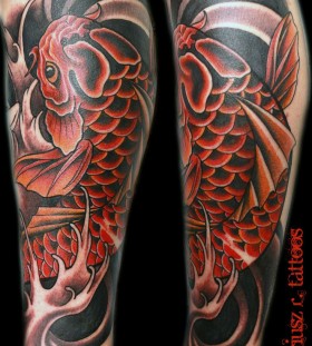 Red and black amazing fish tattoo on leg