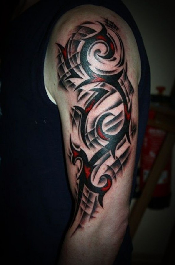 Red and black tribal tattoo on arm
