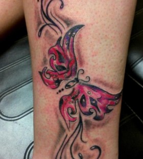 Red and blue butterfly tattoo on leg