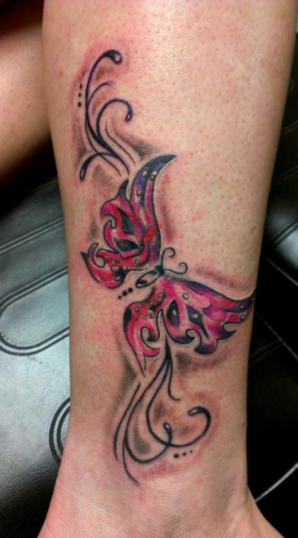 Red and blue butterfly tattoo on leg