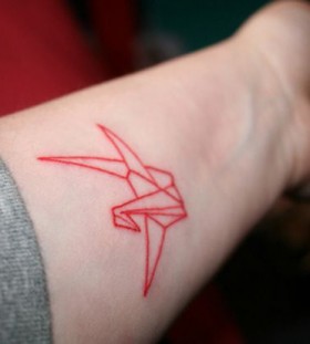 Red bird origami tattoo on arm