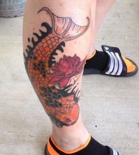 Red flower and orange fish tattoo on leg
