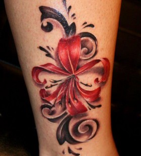 Red flower tattoo on leg