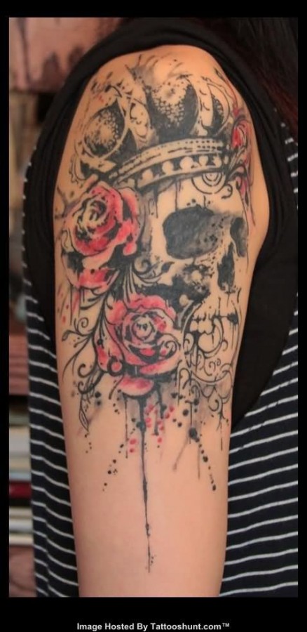 Red flowers and skull tattoo on shoulder