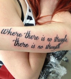 Red hair women quote tattoo on arm