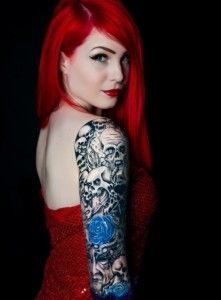 Red hair women skull tattoo on arm