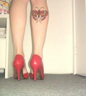 Red heels and butterfly tattoo on leg