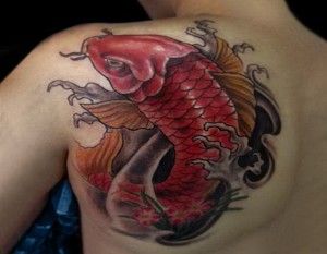 Red koi fish tattoo on arm