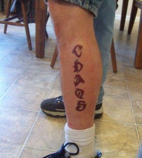 Red letters and quote tattoo on leg