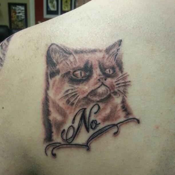 Red lovely cat tattoo on arm