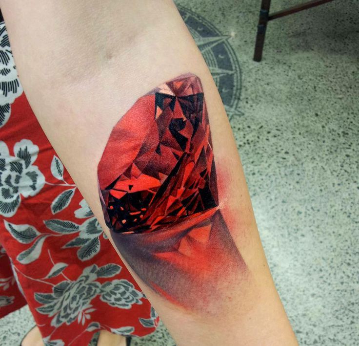 Red lovely crystal tattoo on leg