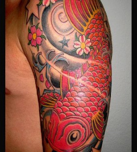 Red lovely fish tattoo on arm