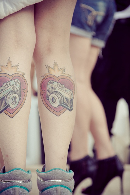 Red lovely heart camera tattoo on leg
