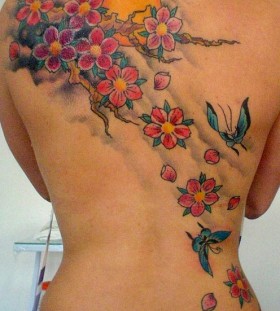 Red, pink and colorful flowers back sun tattoo