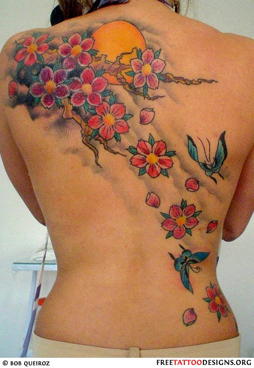 Red, pink and colorful flowers back sun tattoo