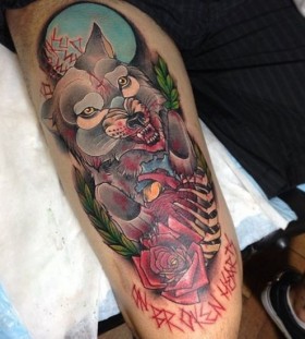 Red rose and angry wolf tattoo on leg