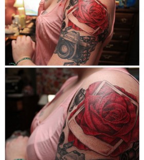 Red rose and pentax camera tattoo on arm
