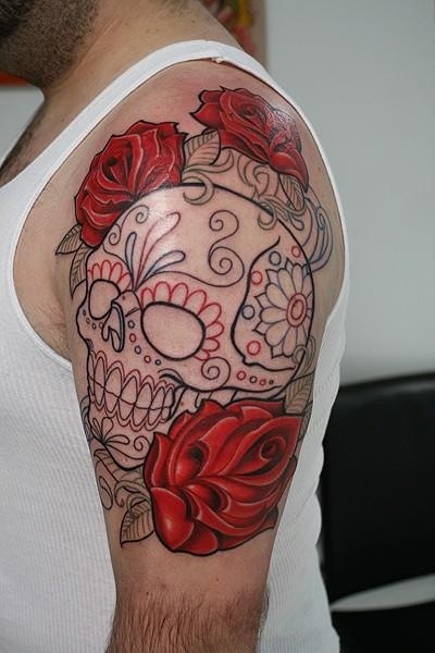 Red rose and skull tattoo on arm