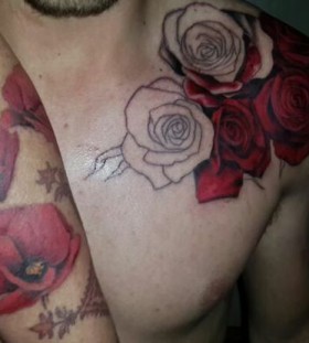 Red rose on shoulder and red poppy tattoo on arm