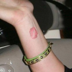 Red simple lips tattoo on arm