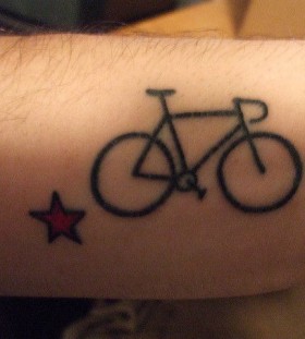 Red star and bicycle tattoo on arm