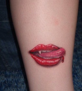 Red tongue and red lips tattoo on arm