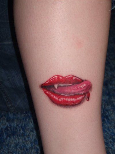Red tongue and red lips tattoo on arm