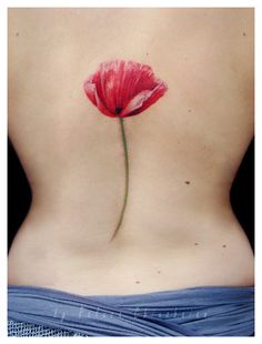 Red tulip tattoo on back