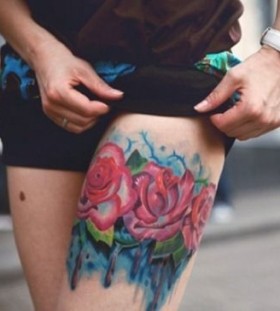 Red watercolor rose tattoo on leg