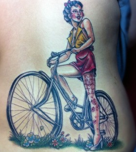 Red women's bicycle tattoo on back